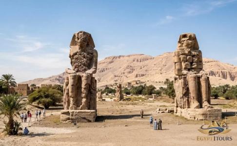 The towering ancient stone statues of Colossi of Memnon guarding Luxor West Bank
